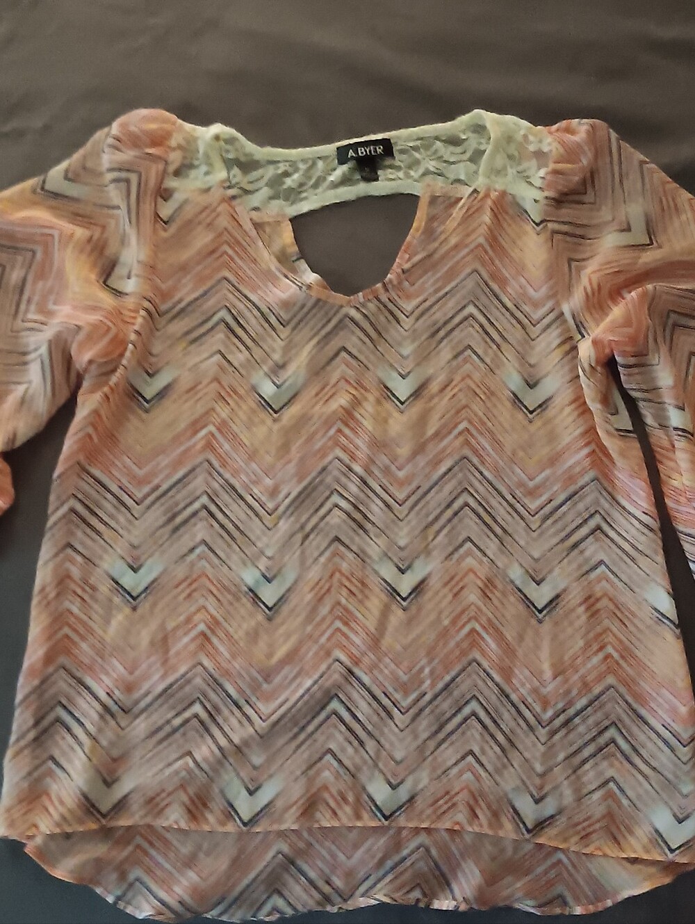 A. Byer Peach and Cream Chevron-Print Keyhole Blouse
